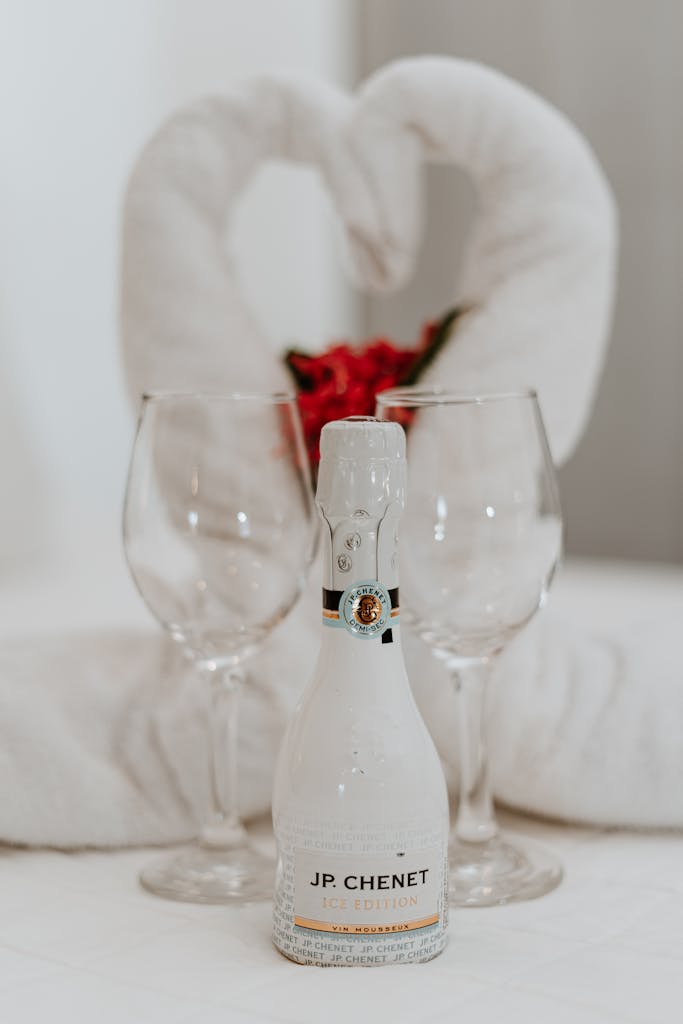 A romantic hotel room scene with a champagne bottle and glasses, perfect for weddings or special occasions.